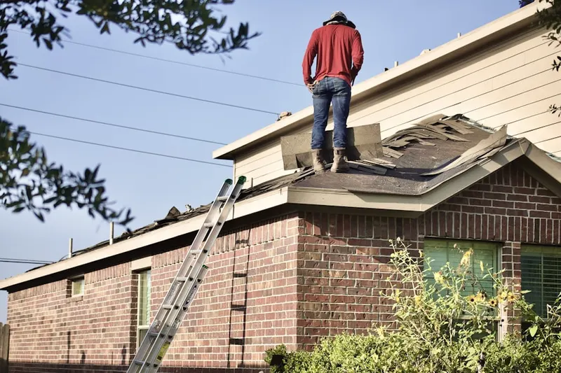 Professional roofer working on a residential roof in Carmel